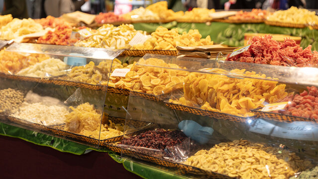 Assortment Of Colorful Dried Fruits Displayed In Trays At Market Stall Including Mango Pineapple And Papaya For Healthy Snacking And Culinary