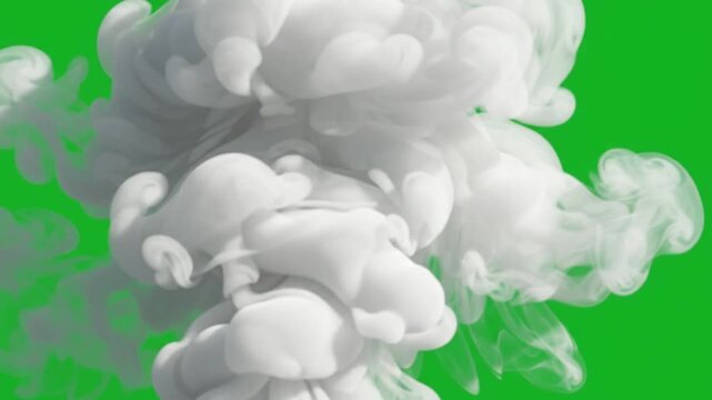 Dense rolling white clouds of swirling vapor expand across a vibrant green screen field while gaseous matter creates complex fluid motions that capture raw natural energy in this dramatic