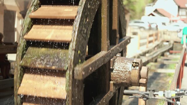 Historic wooden water mill wheel rotating with flowing water in Czech Republic, Europe heritage and renewable energy concept 4k 60fps