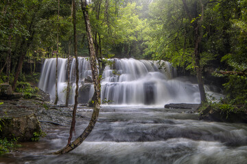 The beauty of Pang Sida Waterfall with water cascading across the entire width of the falls at Pang Sida National Park, Sa Kaeo Province, Thailand. © VespaFoto