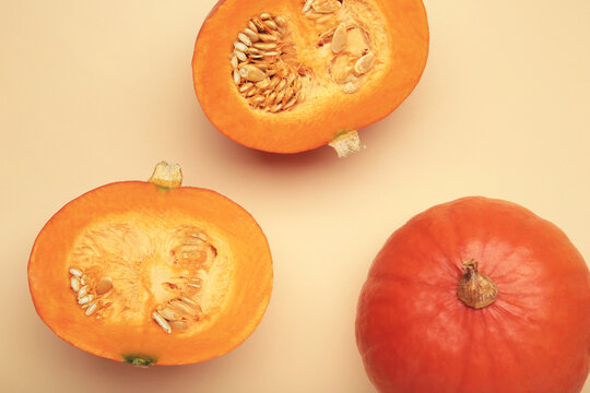 Half of Hokkaido pumpkin on beige background.