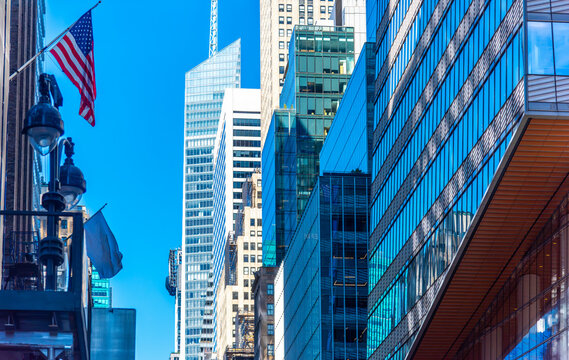 Modern Manhattan skyscraper details under a blue sky