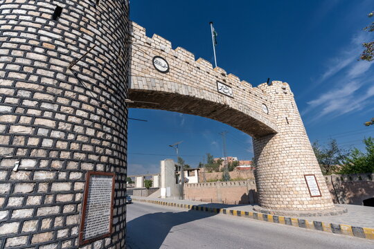 View of the historic stone archway of the Khyber Pass with its defensive towers under a clear blue sky in Khyber District, Khyber Pakhtunkhwa, Pakistan.