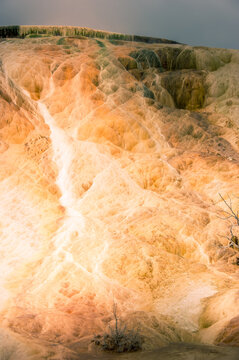 View of the colorful travertine terraces at Mammoth Hot Springs with mineral deposits and unique geological formations in Yellowstone National Park, United States.