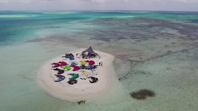 Aerial view of kiteboarding gear scattered on a small sandbank in the turquoise waters of Los Roques archipelago, Los Roques, Dependencias Federale, Venezuela.