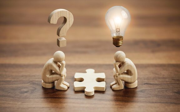 Wooden figurines sitting with puzzle piece question mark and glowing lightbulb symbol representing problem solving and creative thinking in business development.