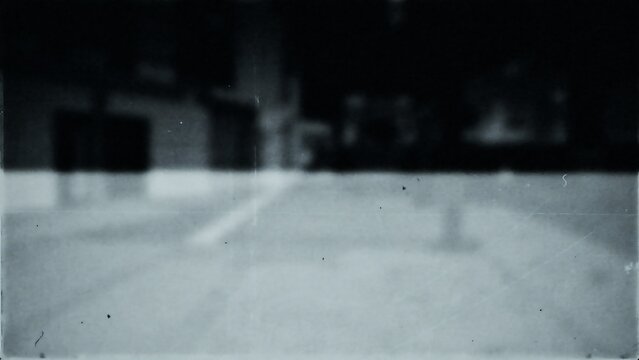 Old faded photograph with vintage blurred street scene, nostalgic retro aesthetic, urban dark photography