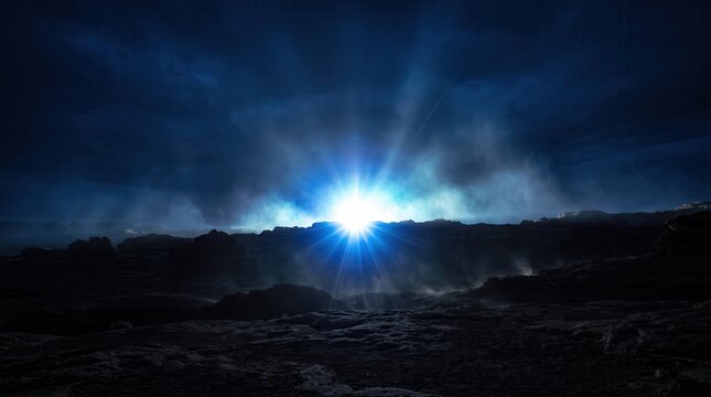 Glowing bright sunburst light breaking through dark clouds over a rugged