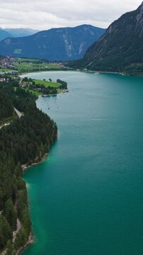 Aerial View Of Lake Achensee Flanked By Karwendel And Rofan Mountain Ranges In Tyrol, Austria. vertical, panning tilt-up shot