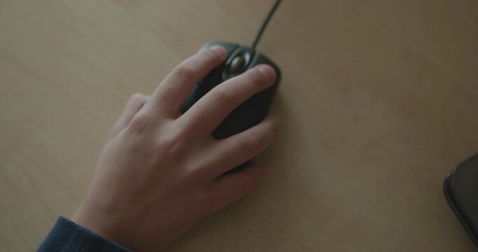 Close-up children's hand use computer mouse. 4K 10-bit