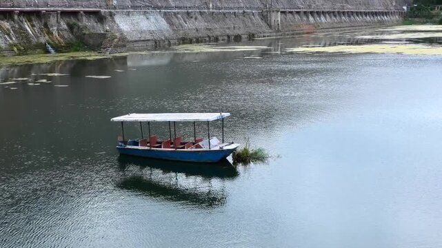 An isolated boat parked in the lake near Brindavan Gardens, Mysore, Karnataka, India