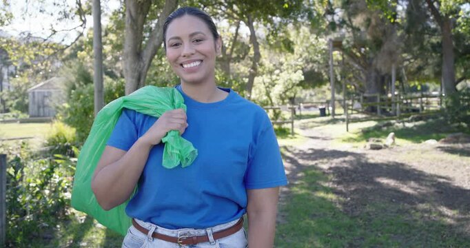 African American woman standing in sunlit paddock holding green bag smiling and laughing at camera