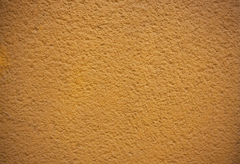 Tynk strukturalny koloru żółtego na ścianie budynku. Yellow textured plaster on a building wall. © 123108 Aneta