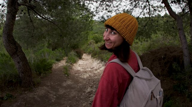 A beautiful young, happy adult girl was hiking with a backpack in the forest. Portrait of an active girl smiling. Mountain of Carmel. Haifa. Israel. 