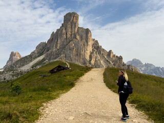 Obraz premium tourists walking in the dolomites at giau pass in summer italy