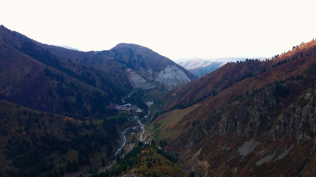 Cinematic autumn landscape of Almaty, Kazakhstan, featuring colorful mountain scenery, snowy Tien Shan peaks, Shymbulak ski resort, Medeu and the cable car.