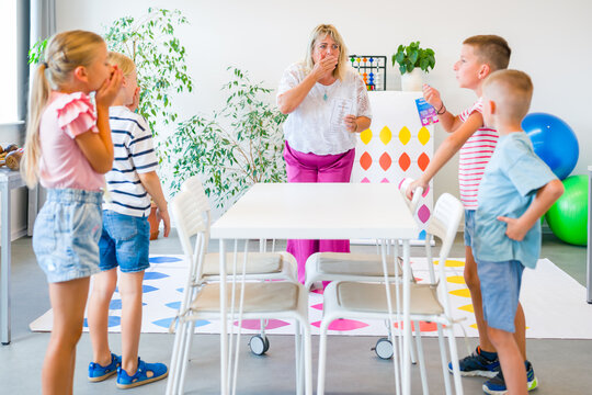 Kids having fun with therapist during occupational therapy activity.