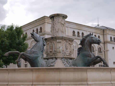 View of the bronze horse fountain with neoclassical architecture in the background in Skopje, Greater Skopje, North Macedonia.