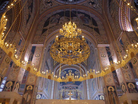 View of the ornate interior of the Church of Saints Constantine and Helena featuring a large golden chandelier and intricate frescoes in Shkupi, Qyteti i Shkupit, North Macedonia.