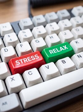 Close-up of a computer keyboard featuring large red stress key and large green relax key among white keys
