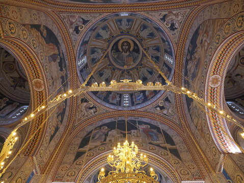 View of the ornate interior of the Church of Saints Constantine and Helena featuring detailed religious frescoes and a golden chandelier in Shkupi, Qyteti i Shkupit, North Macedonia.