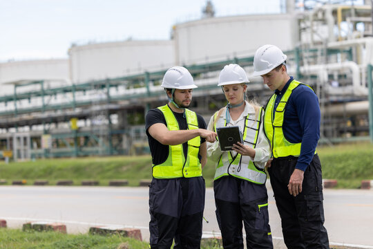 Group of petroleum engineers having a discussion at oil refinery site
