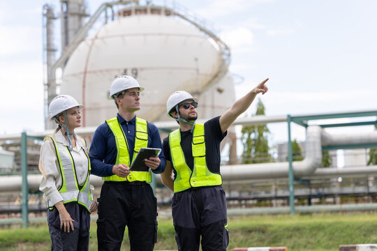 Group of petroleum engineers having a discussion at the site