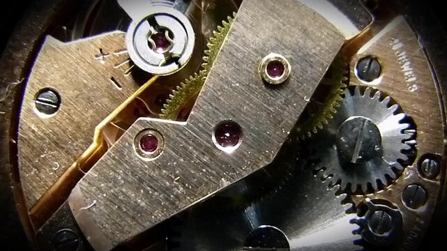 Macro shot of a working vintage watch mechanism with moving gears and cogs
