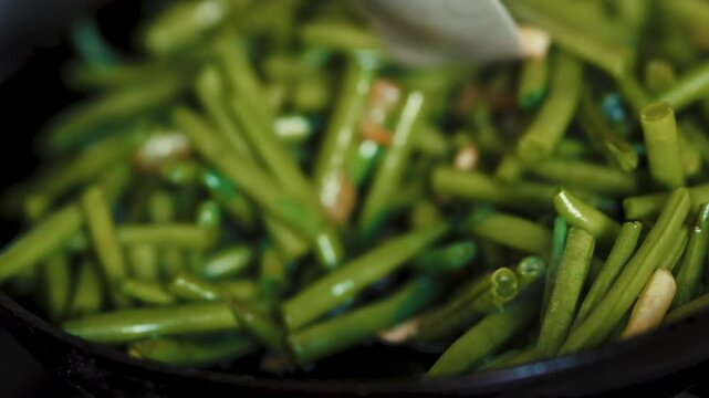 Stirring vegetable dish with a white spatula during frying