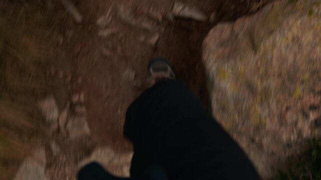 POV view of hiker walking along rocky path in high alpine in Principality of Andorra, active nature. First person POV perspective of walking on mountain trail at Pyrenean mountain, outdoor hiking.