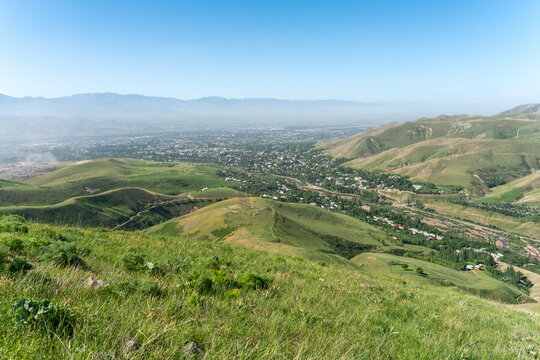 High angle view of Uzbek city Angren in late Spring, rolling green hills