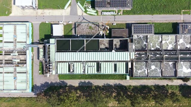 Aerial view of water treatment plant with filtration tanks and industrial infrastructure in Milan, Lombardy, Italy.
