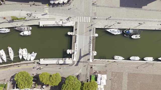 Aerial view of the canal bridge with boats moored along the canal in Cervia, Emilia-Romagna, Italy.