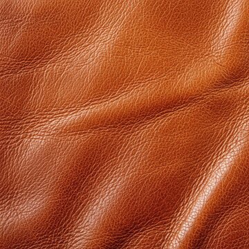 Close up view of aged and worn leather surface with soft selective focus showing rich warm tones and natural grain for vintage backgrounds, rustic, close-up, creases