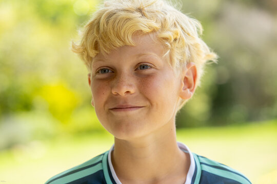 outdoor portrait of beautiful smiling blond boy age 11