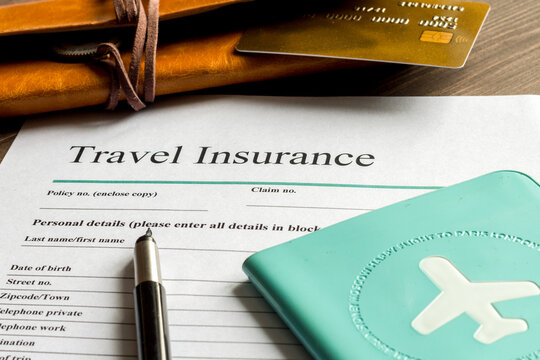 concept booking travel insurance on wooden background