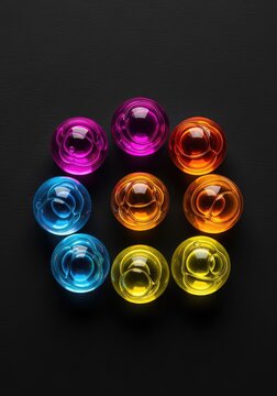 Transparent spheres of liquid rest on a deep charcoal background, showcasing intricate surface tension and glowing highlights in close-up, sparkle, fluid, hydro