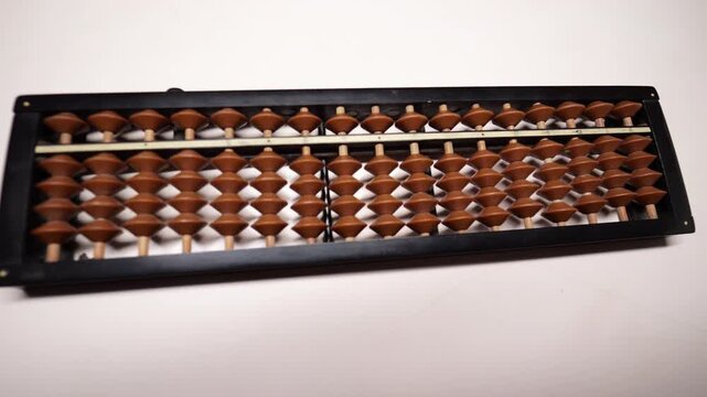 Slow-motion fingers calculating on an abacus.
