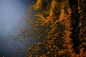 Fototapeta premium Curry Powder Lines on Black Textured Background with Copy Space