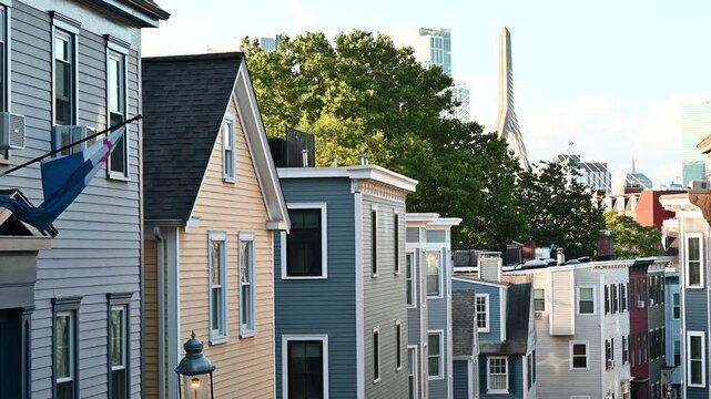 View of Boston from the city of Charlestown with its colorful homes and the iconic Zakim Bridge on a sunny morning.