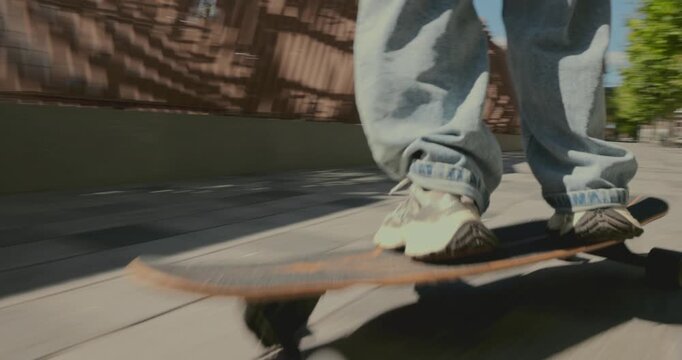 Close tracking shot follows young woman cruising on longboard along sunlit urban promenade with easy confidence. Skate culture, city recreation and personal freedom concept.