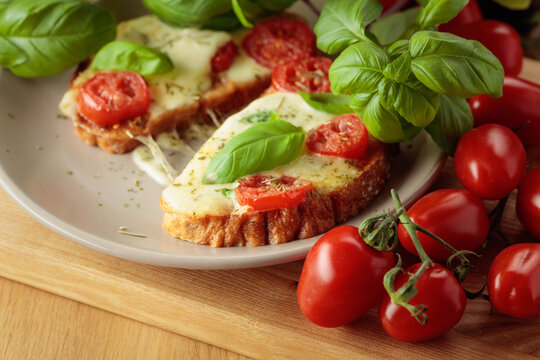 Hot open sandwiches with mozzarella, tomatoes and basil.