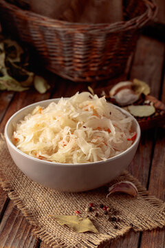 Sauerkraut with ingredients on a rustic background.