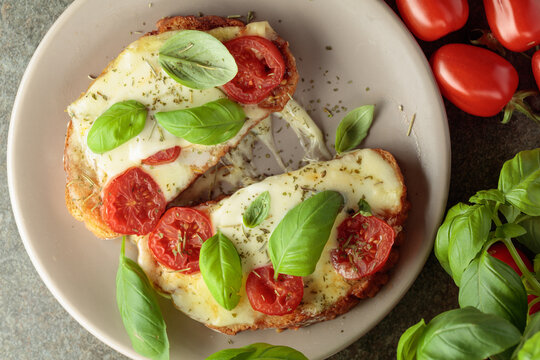 Hot open sandwiches with mozzarella, tomatoes and basil.