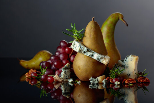Blue cheese with pear, walnuts, red grapes, and rosemary.
