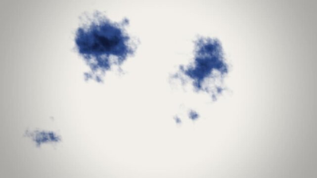 Dark blue ink blooming and spreading in water creating abstract cloud shapes on a light background