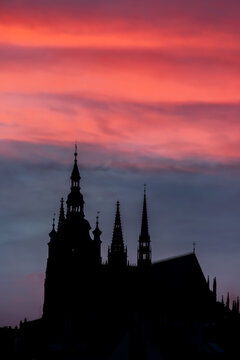 Dark silhouette of St Vitus Cathedral against burning sunset sky. Prague, Czech Republic 