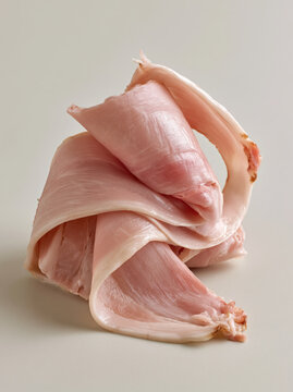 Curved ham slice raw meat pink pork fresh ham gourmet food protein macro closeup minimal background culinary ingredient soft texture folded ham slice sculpture, raw pink pork meat detail