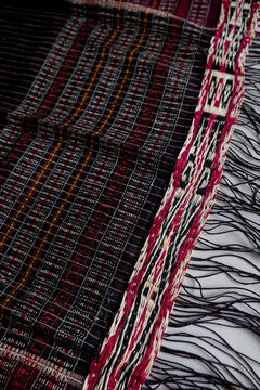 Traditional Indonesian ulos woven fabric with red and black patterns