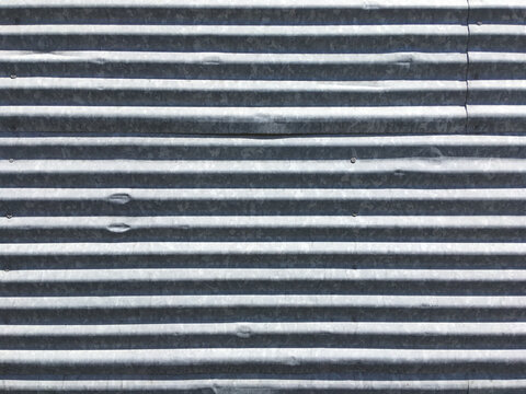Section of a wall of corrugated metal sheets